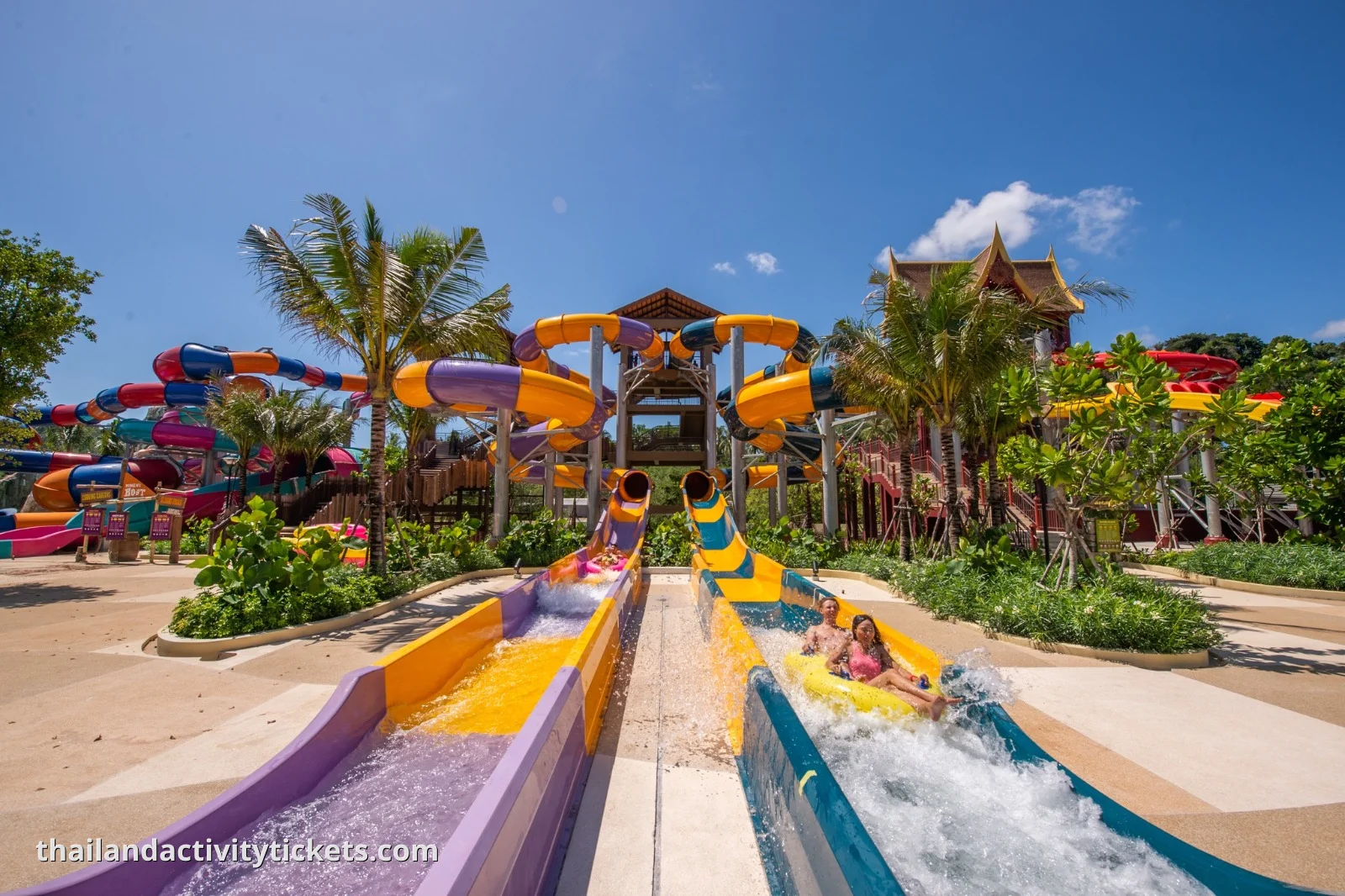 Tourists racing head-first down the six-lane Racing Nagas water slide in Phuket