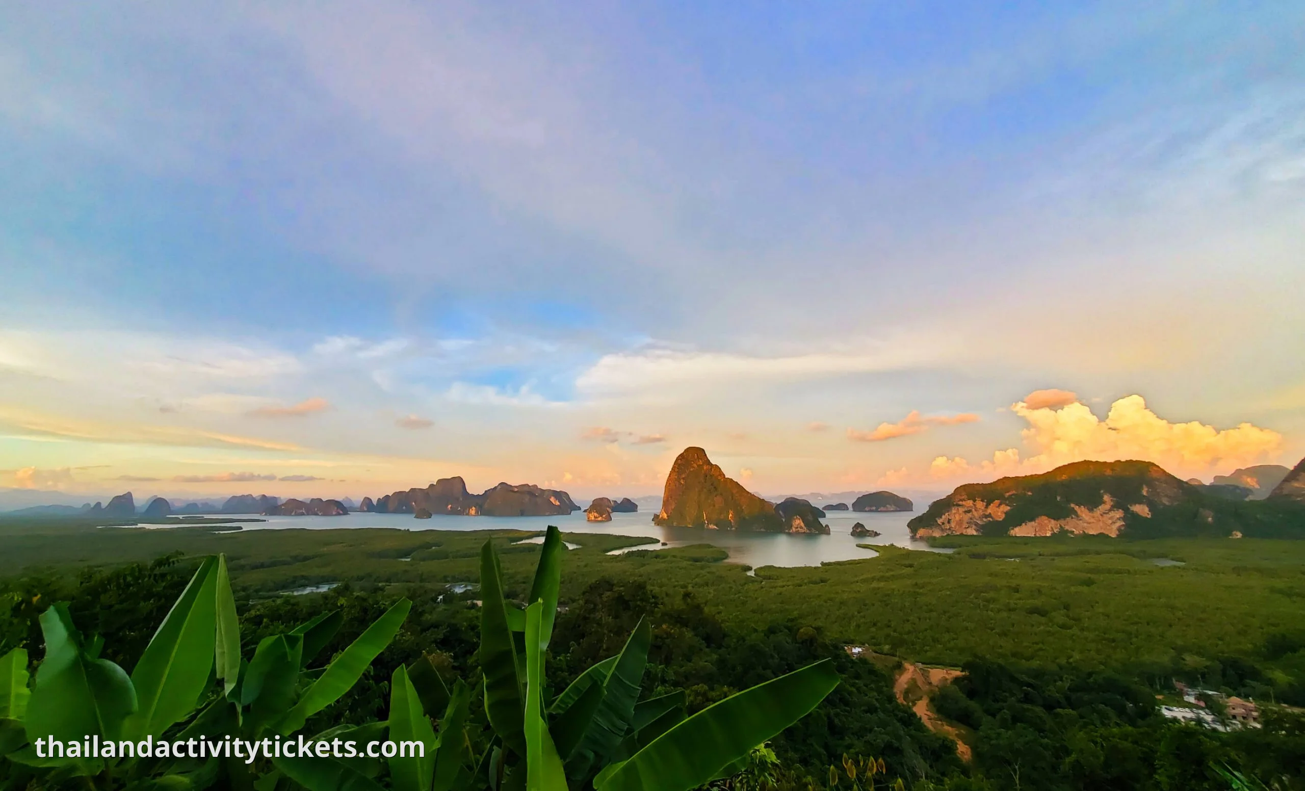 Tourists exploring hidden lagoons in Phang Nga Bay on canoe