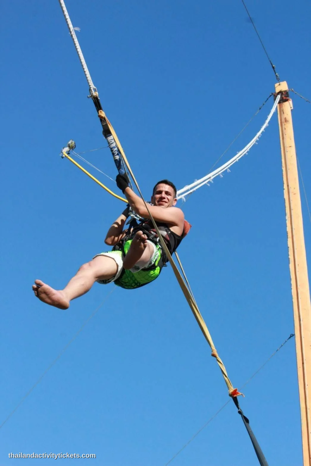 A thrill-seeker performing a 60-meter bungee jump over the lake at Changthai Thappraya Safari.