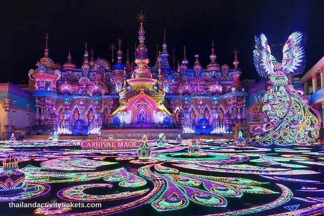 A tourist taking a night photograph of the massive, colorful LED light sculptures reflecting across the lake inside the Kingd