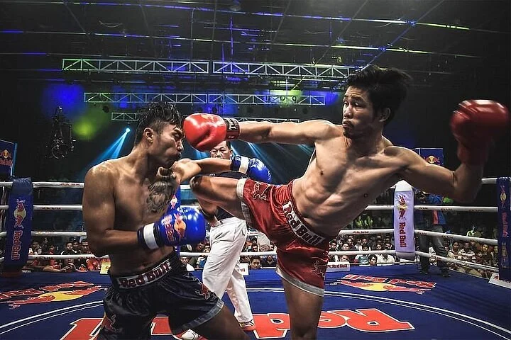 Referee overseeing a Muay Thai bout at JF Boxing Stadium Pattaya