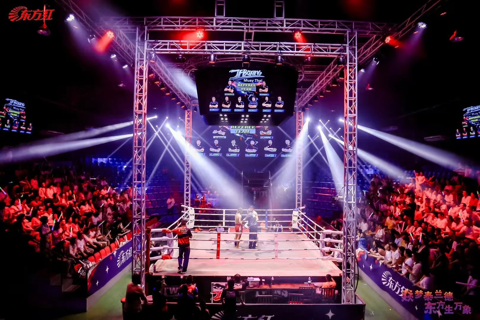 Referee overseeing a Muay Thai bout at JF Boxing Stadium Pattaya