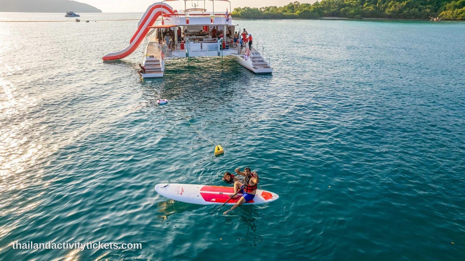 Travelers snorkeling in the clear blue waters of Koh Rin near Pattaya, Thailand.