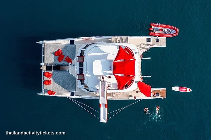 Travelers relaxing on the trampoline nets of a luxury yacht trip in Pattaya.
