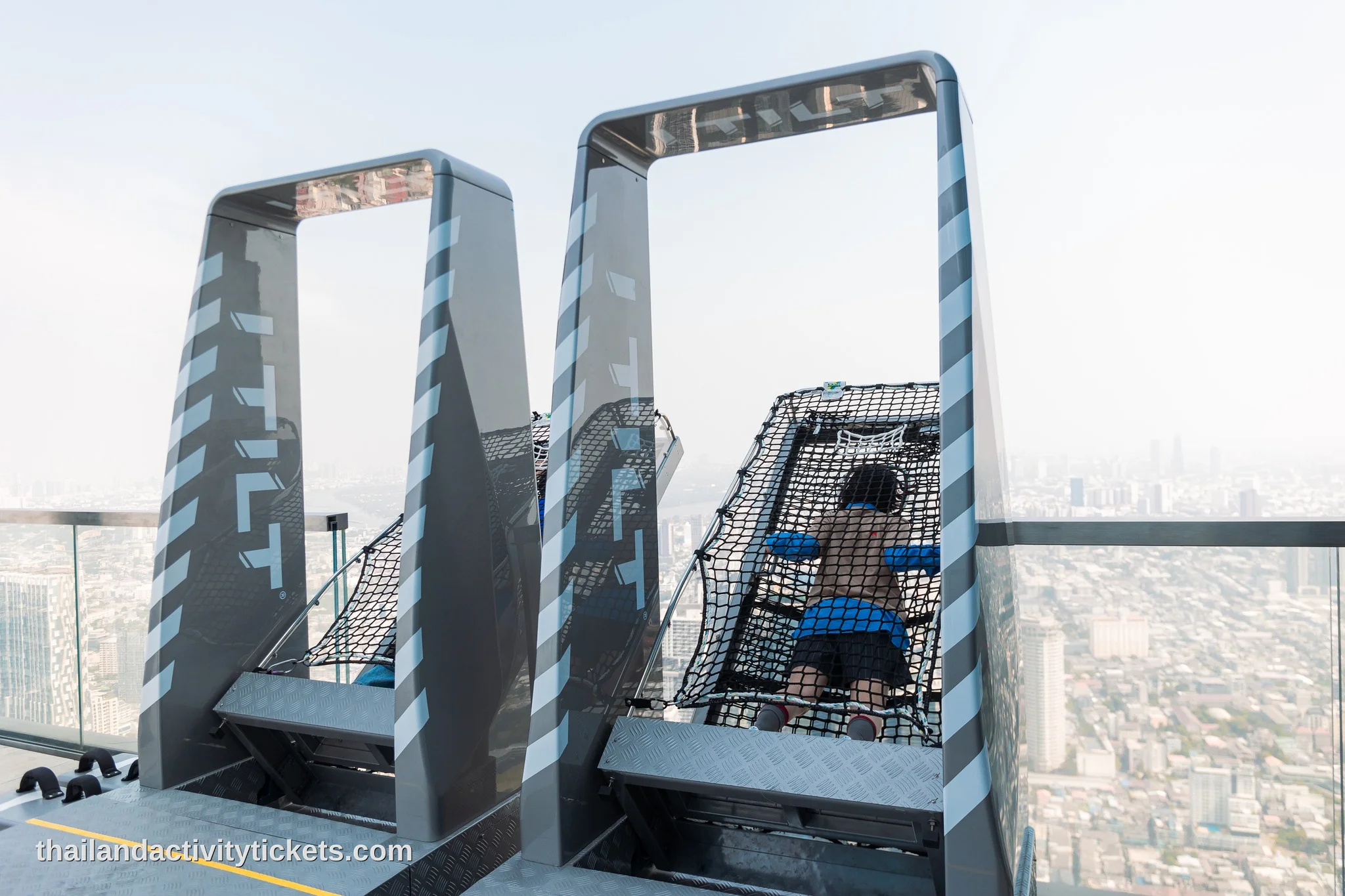 Visitors enjoying the glass tray at Mahanakhon SkyWalk