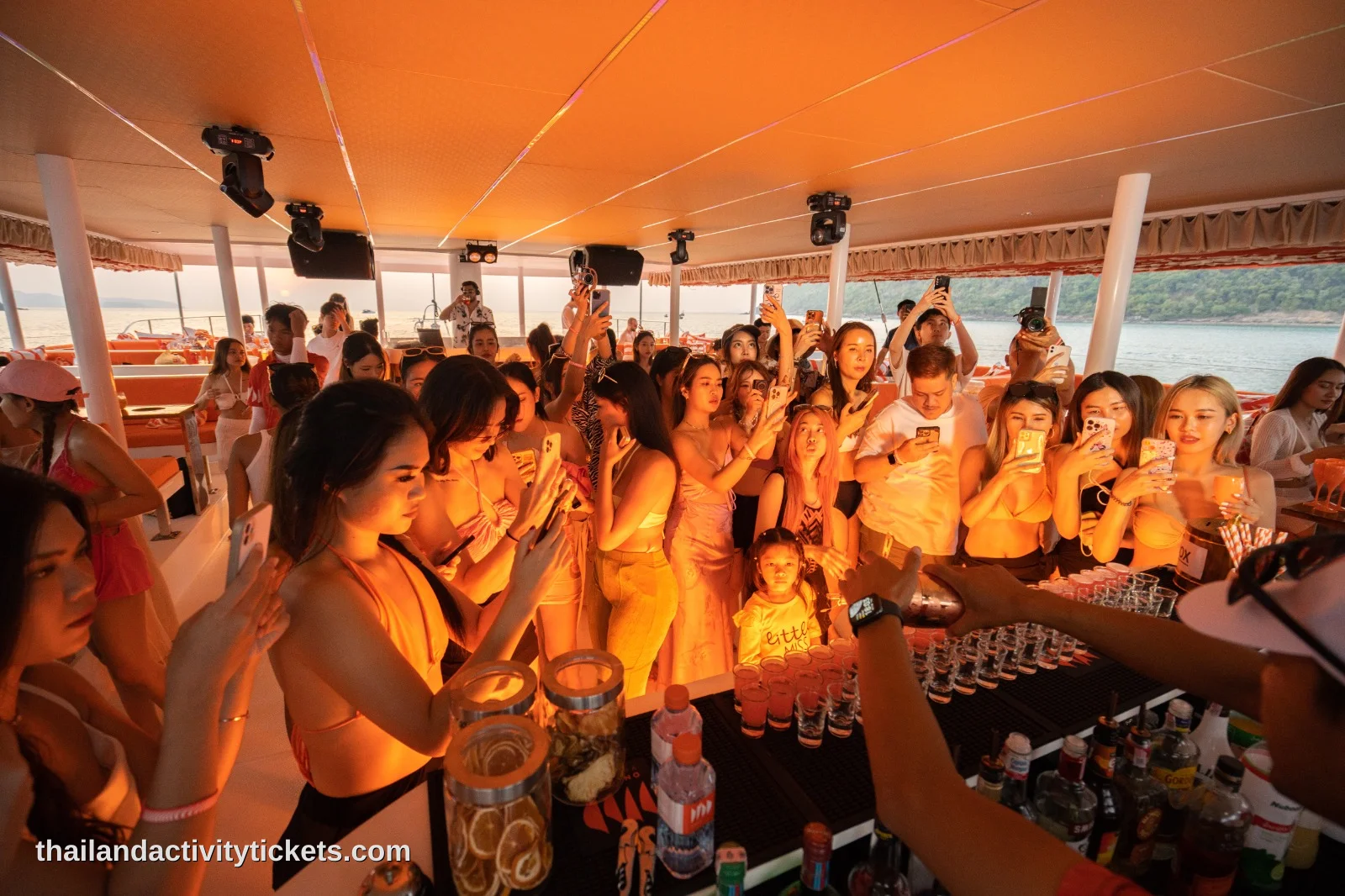pattaya catamaran party with dj music and guests dancing onboard yacht