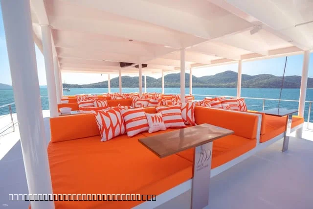Tourists relaxing on catamaran bow nets Pattaya 3 islands tour Gulf of Thailand