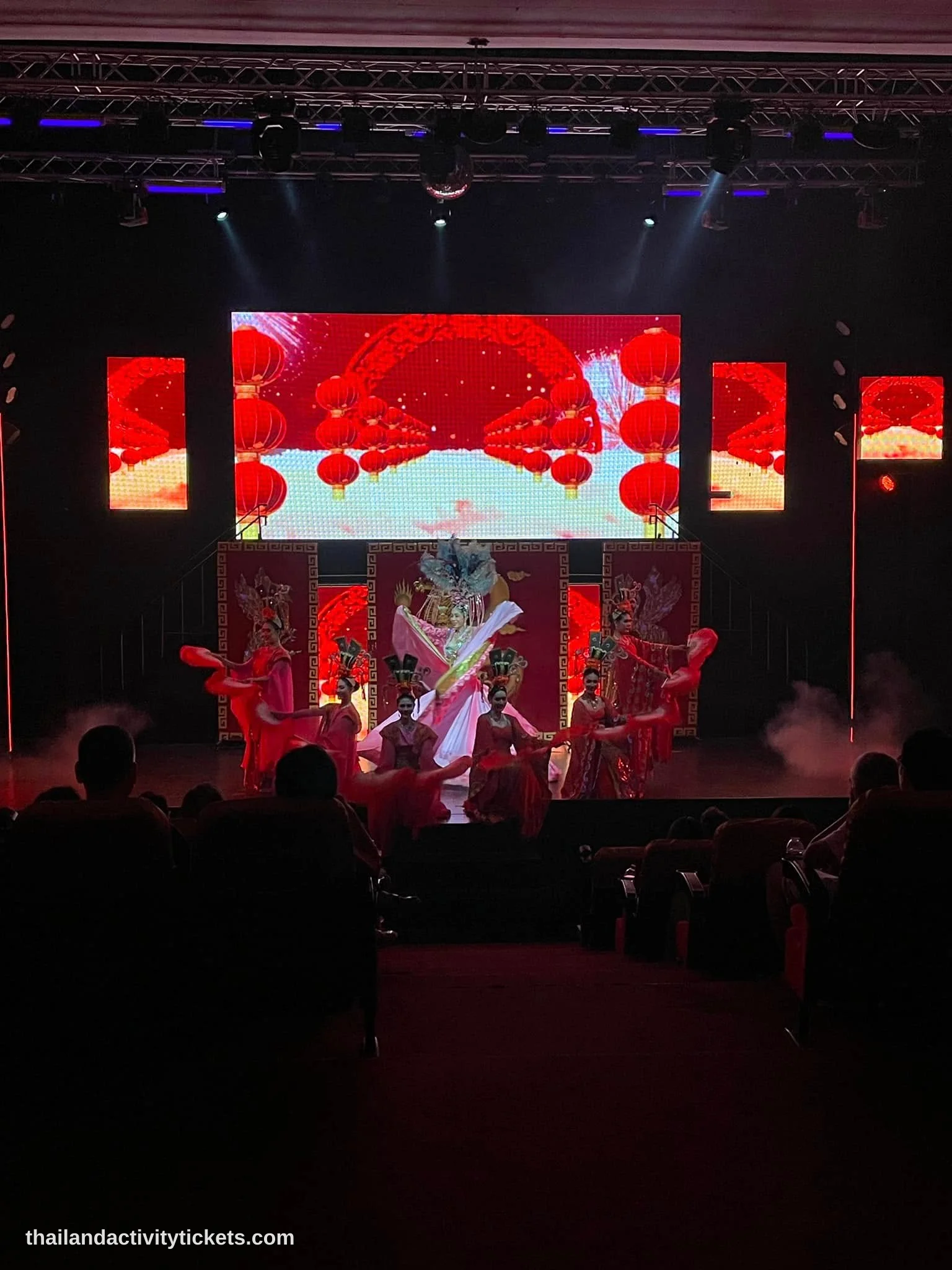 Tourists taking photos with performers after Siam Dragon Cabaret Show