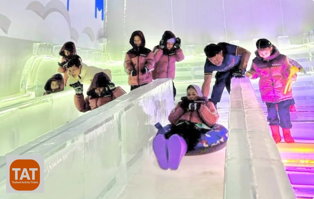 Visitors sliding down the ice slider lanes at Winter Wonderland Pattaya